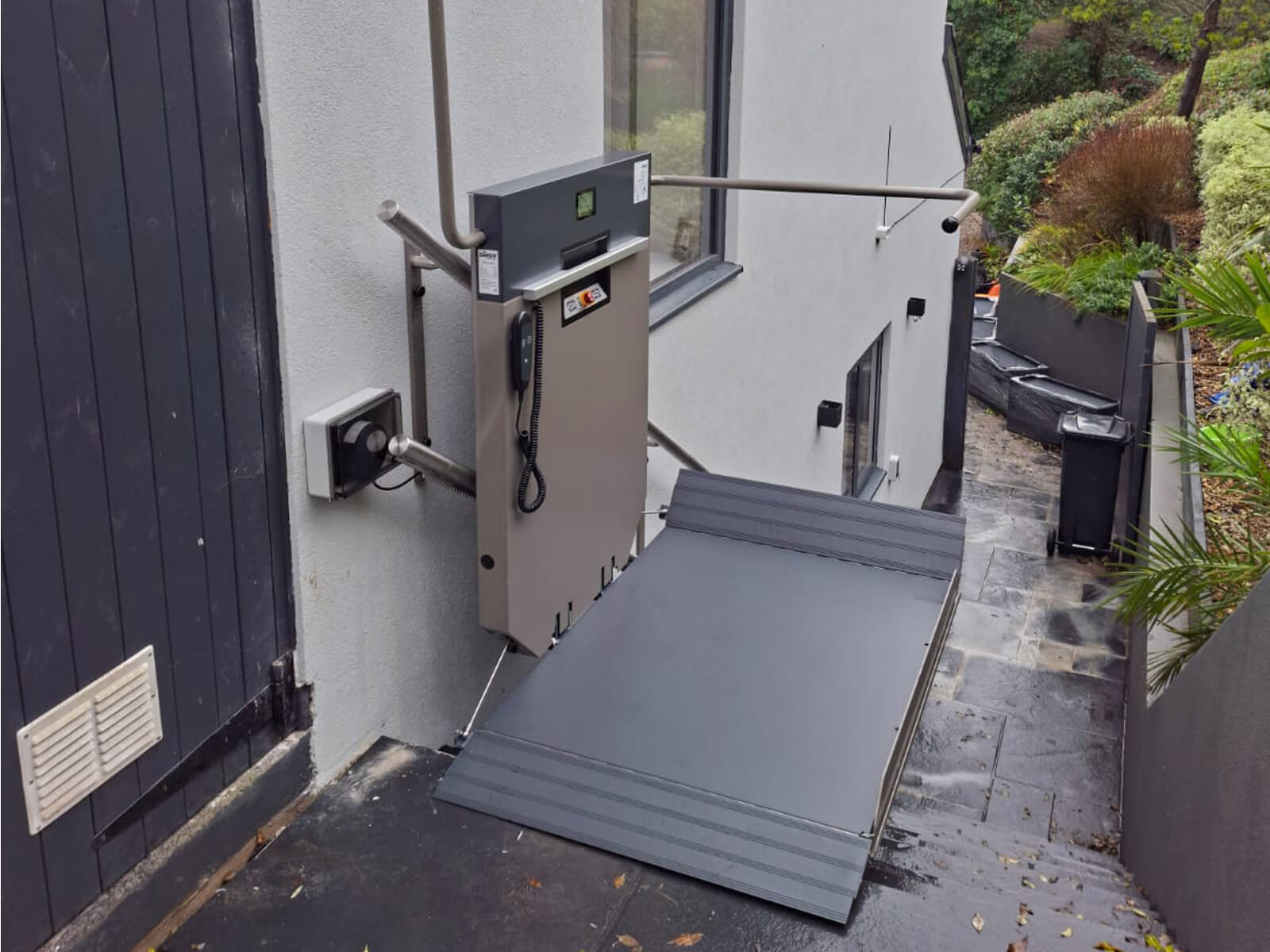 Platform stairlift at the top of a flight of steps