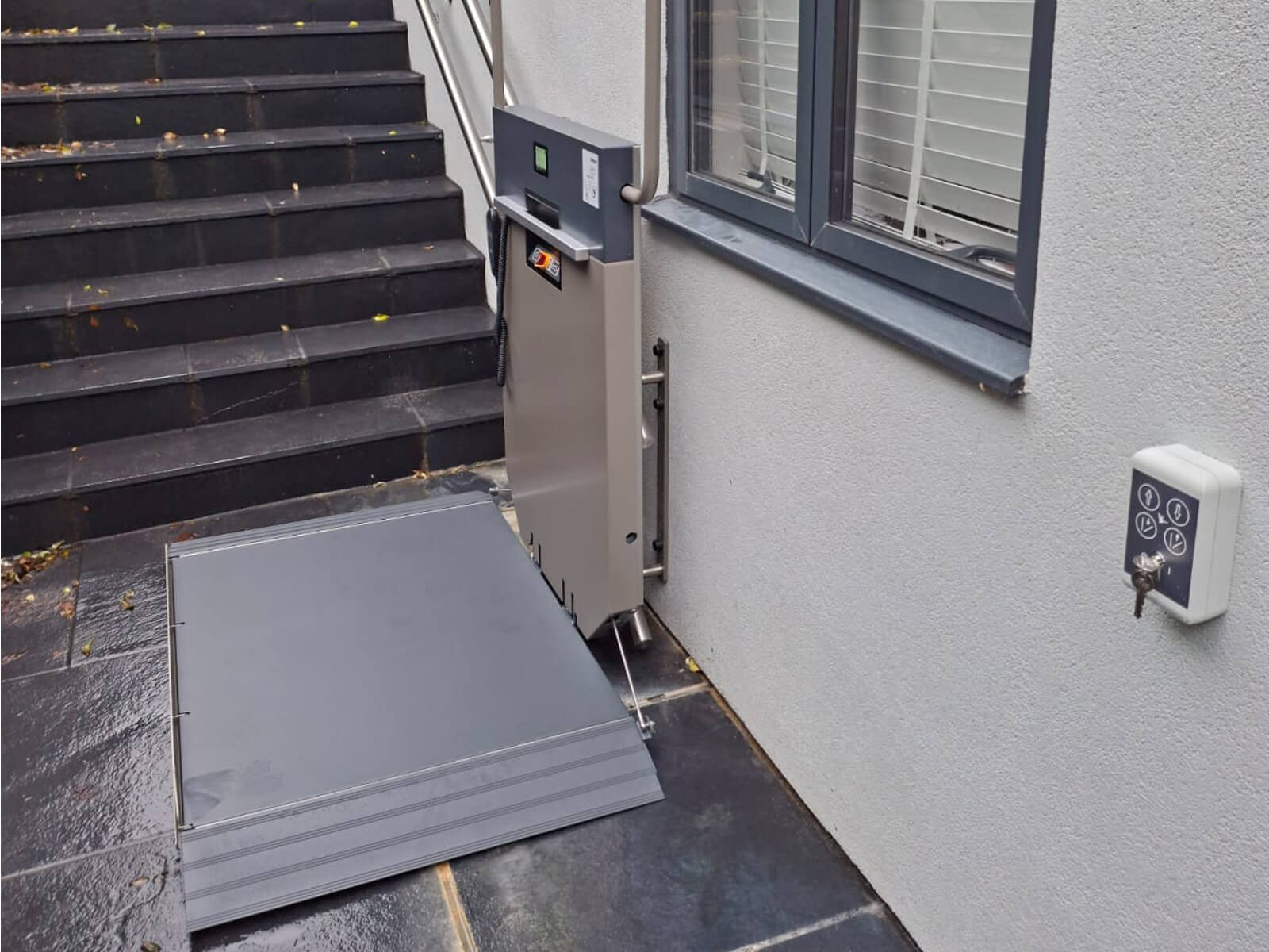Platform stairlift at the bottom of a flight of steps