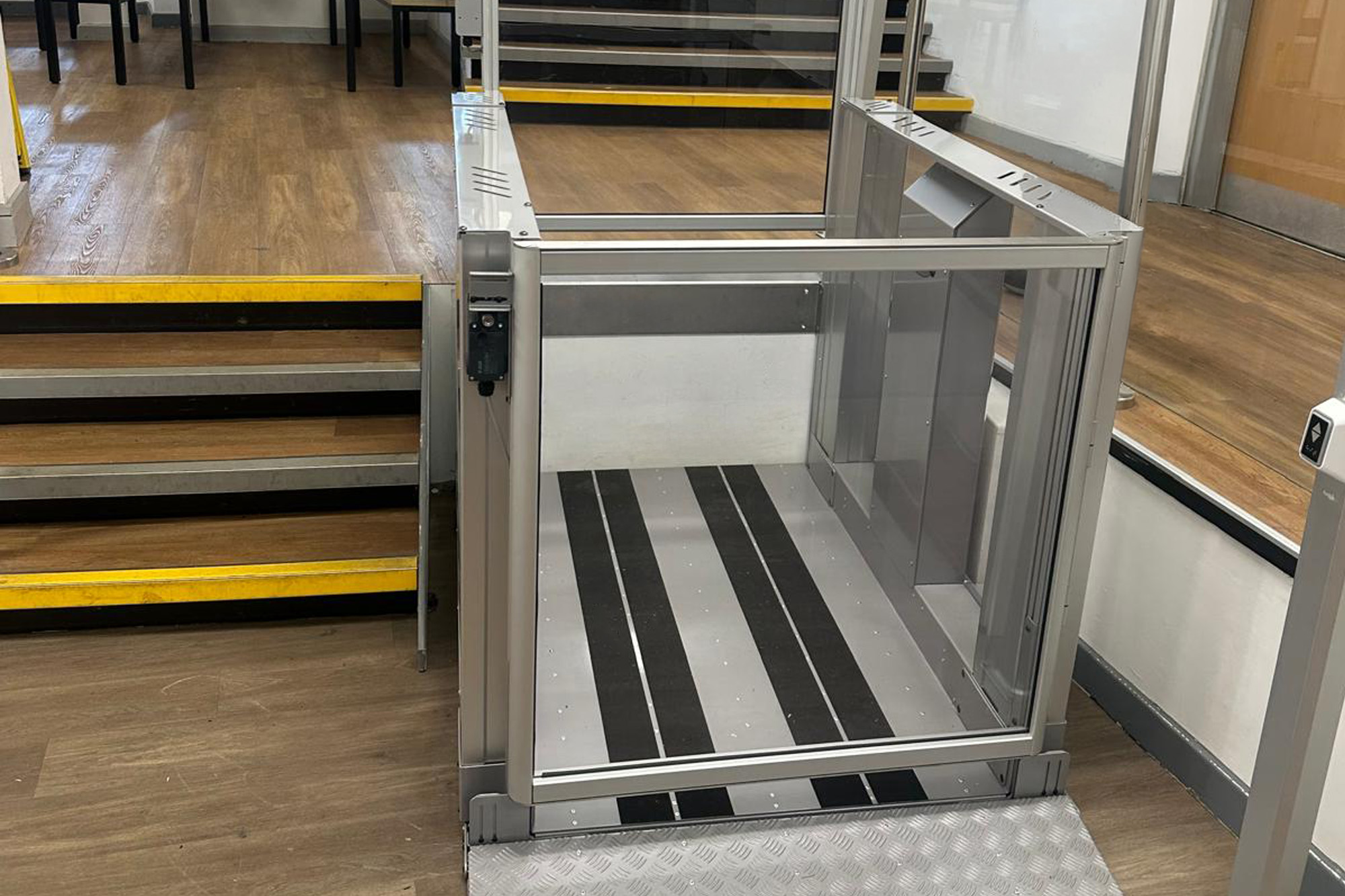 Step lift installed next to a flight of steps at Stamford College.