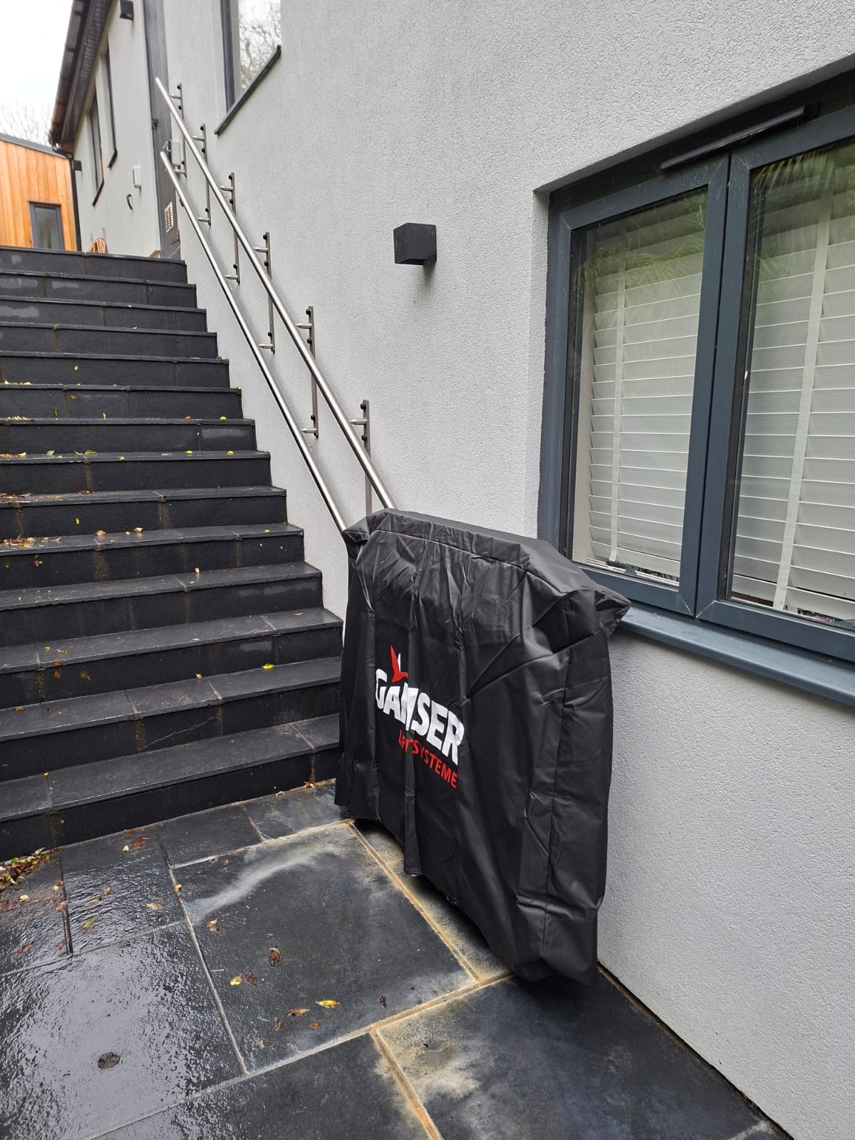 Platform stairlift with a black cover over it