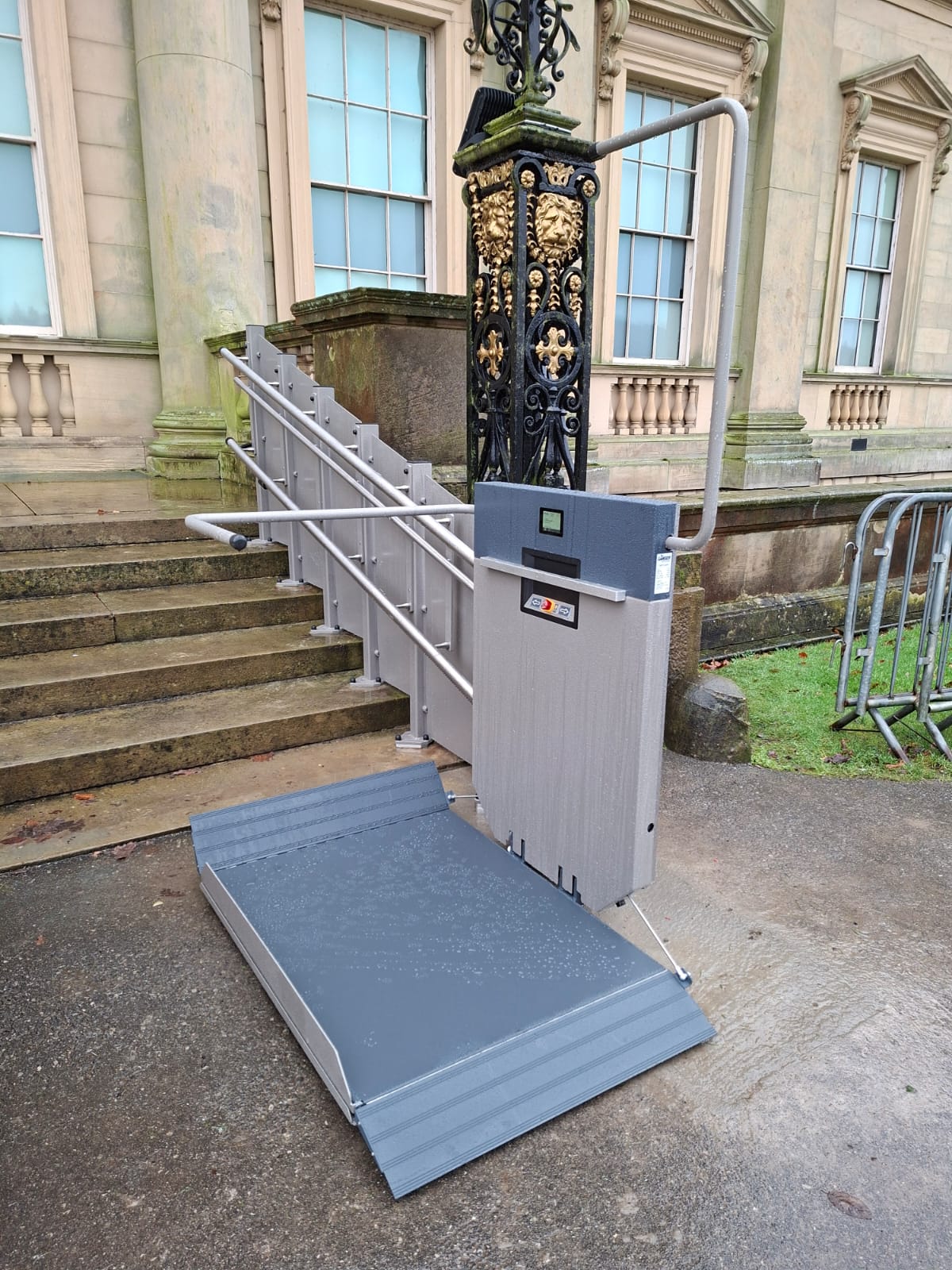 GTLE inclined stairlift installed on the external entrance steps at Harewood House, shown with platform deployed at ground level.