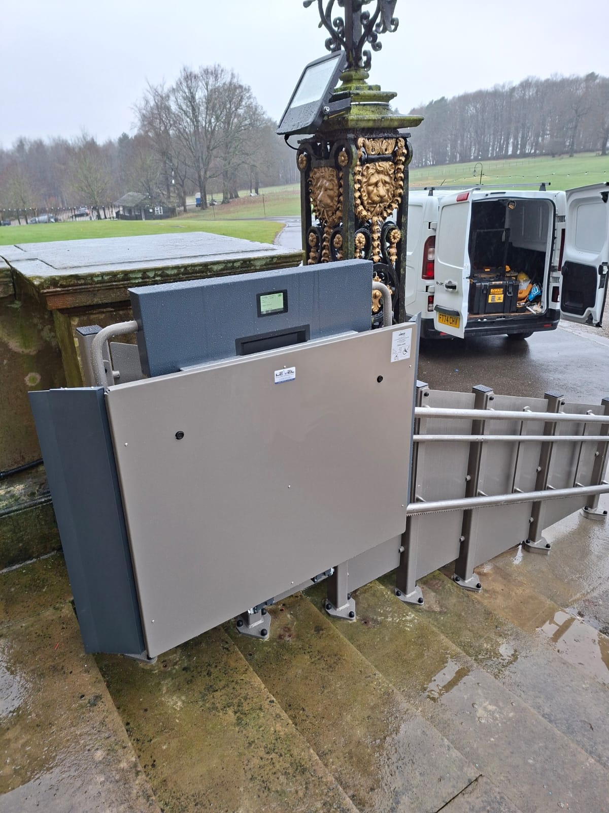 GTLE platform stairlift installed on the main entrance steps at Harewood House, with bespoke rail system and offset wall fixing.