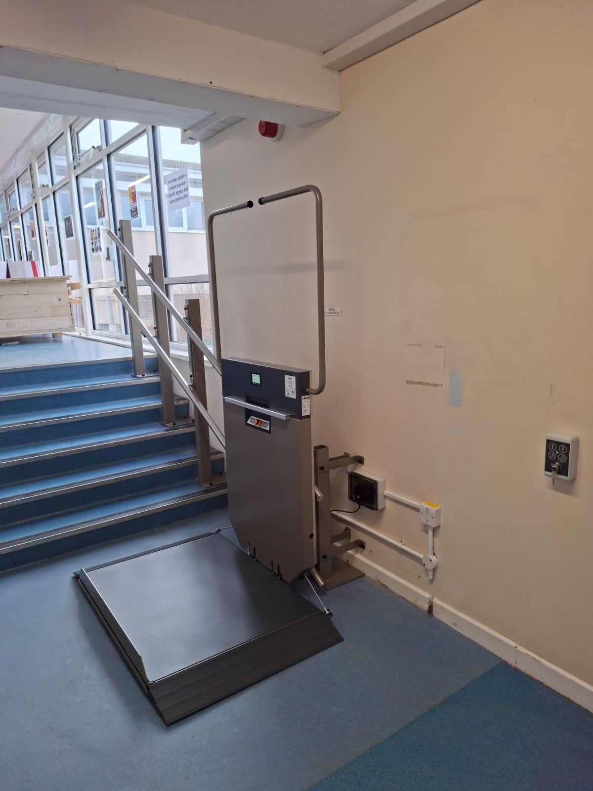 GTLE platform stair lift at lower landing position at Filey Academy, platform deployed for wheelchair access.