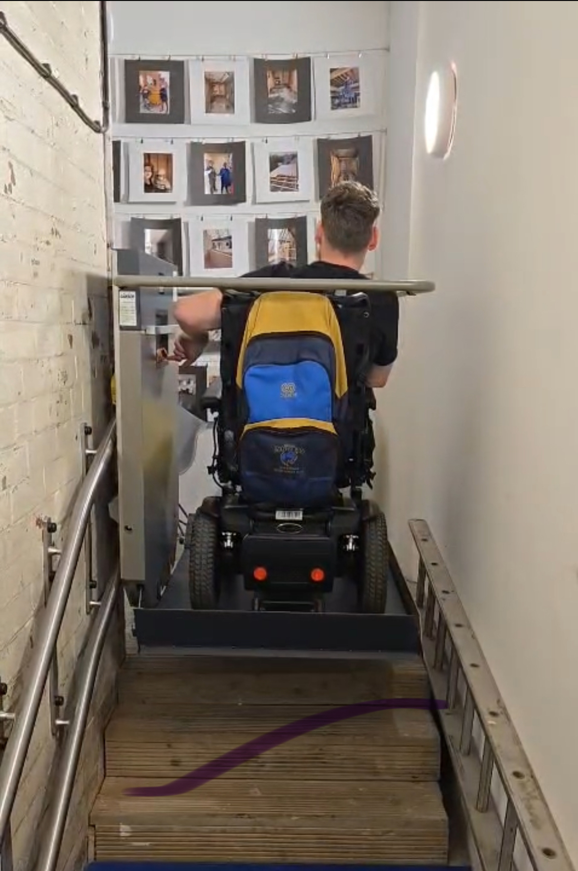 Wheelchair users going up the stairs with a platform stair lift