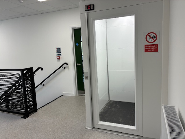 Vertical platform lift next to the stairs at the Food Museum