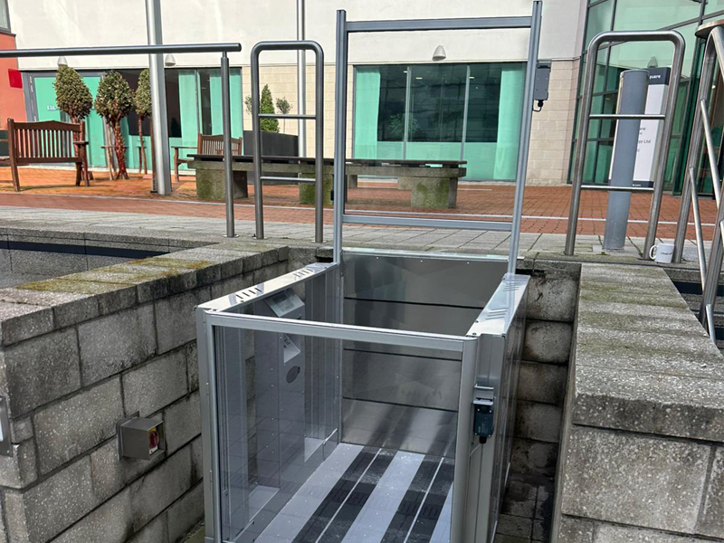 Tech Lift M4 external step lift at Colton Square, Leicester, showing glazed doors.