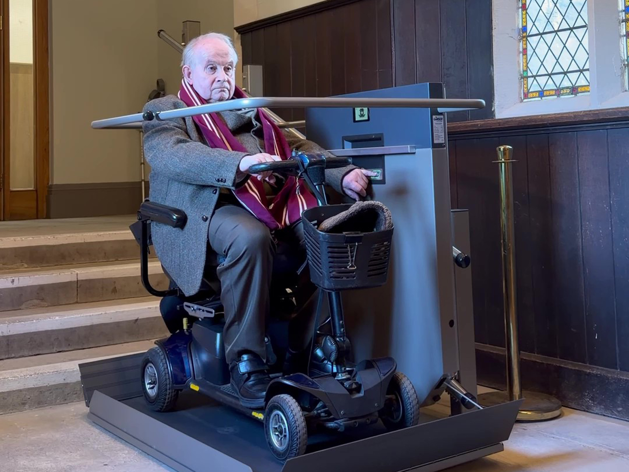 Visitor on mobility scooter on the GTLE platform stair lift at lower level, Ushaw Historic House chapel