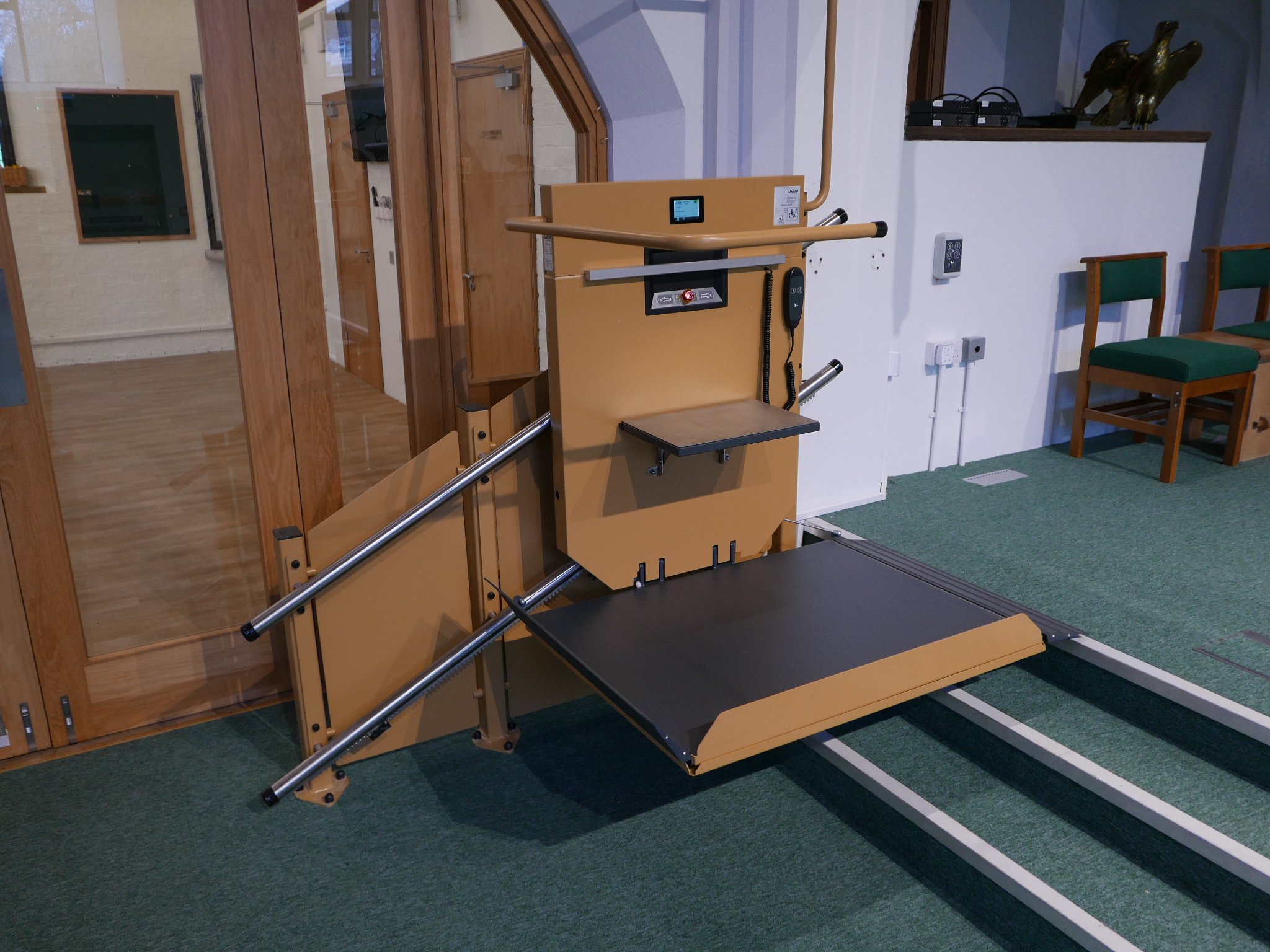Level Access Lifts GTLE inclined stairlift with wheelchair platform extended with a fold down seat at the base of the chancel steps, side view