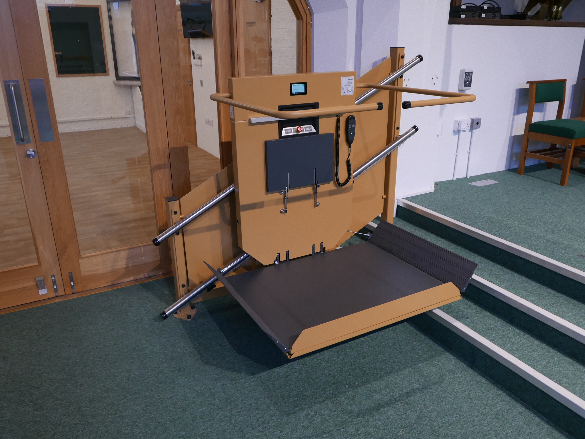 Front view of the GTLE inclined stairlift at St Oswald's Church with wheelchair platform fully deployed and safety arms open