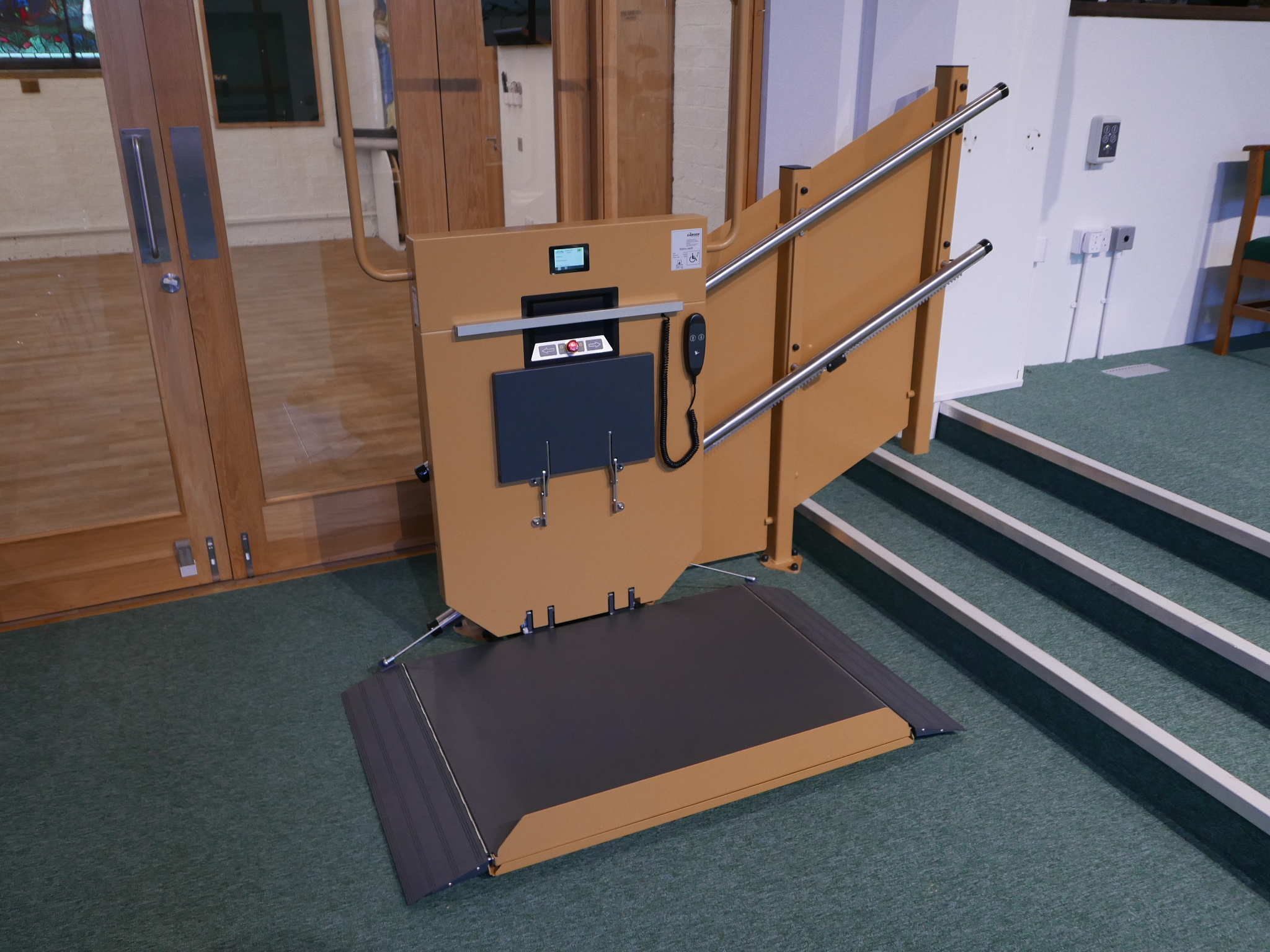 GTLE inclined stairlift with platform lowered to floor level, ready for wheelchair access at St Oswald's Church chancel steps