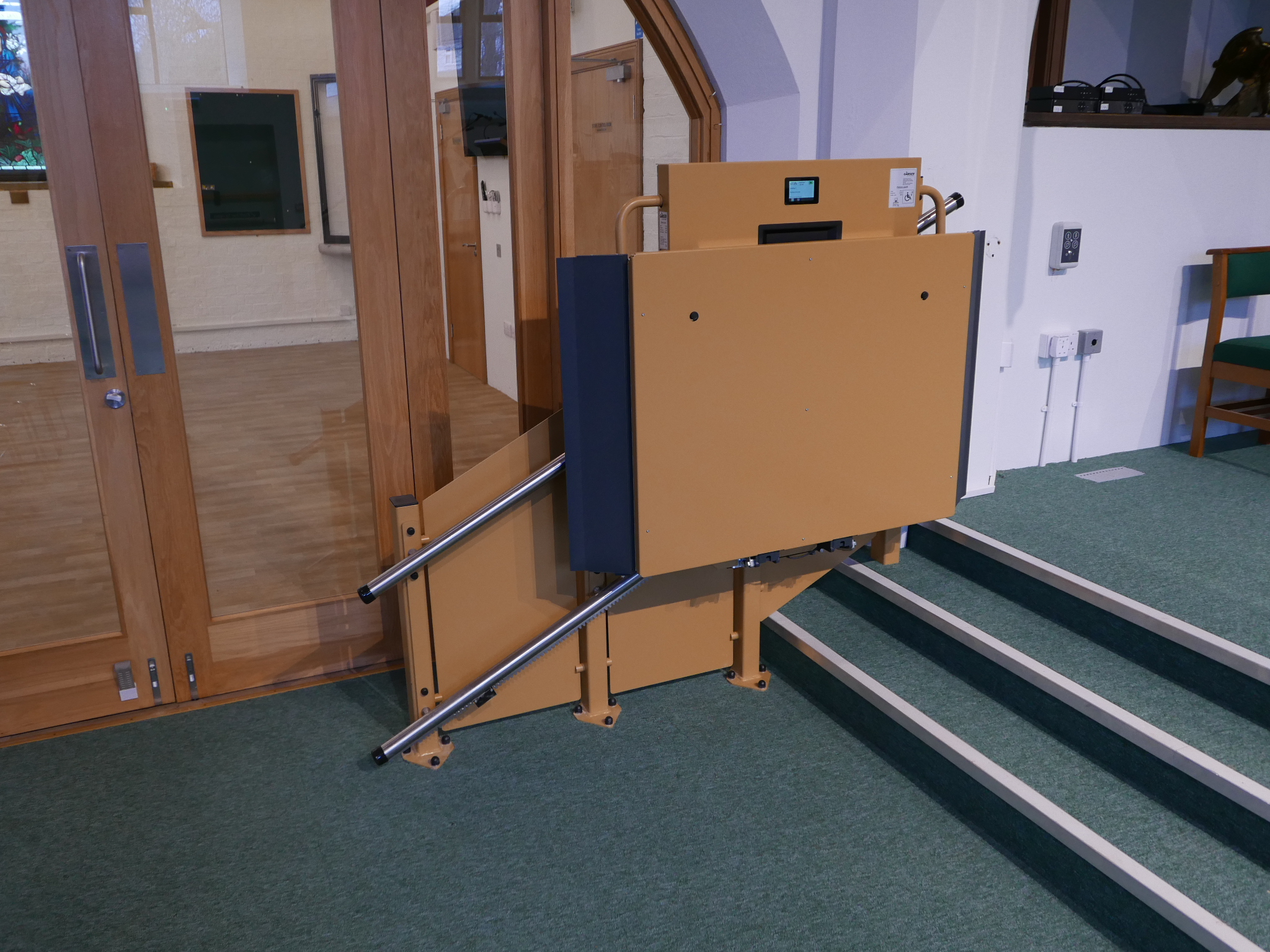The GTLE inclined platform stairlift in folded position at the top of the chancel steps at St Oswald's Church, Rugby
