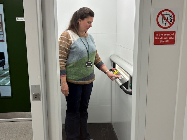 Person operating a vertical platform lift solution