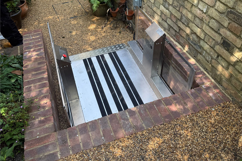 A silver step lift in a garden