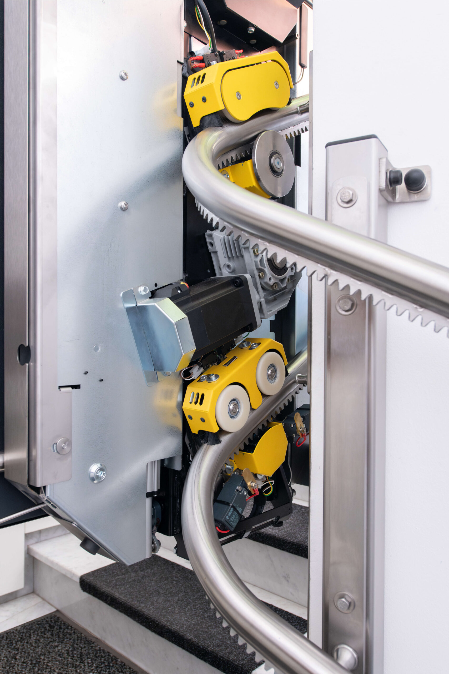 Two yellow cog fixings attached to a rail