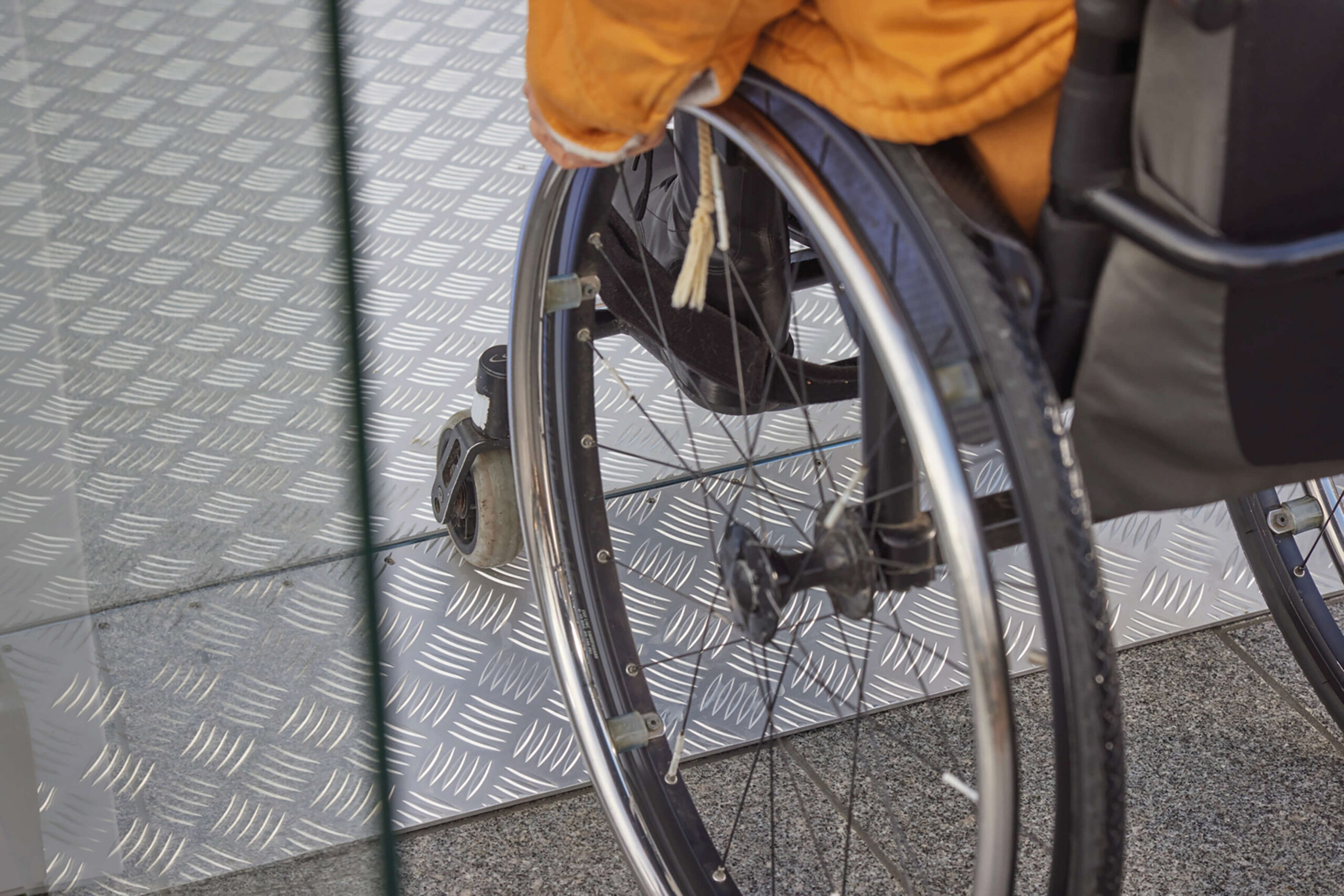 Wheelchair going up a ramp to a platform lift