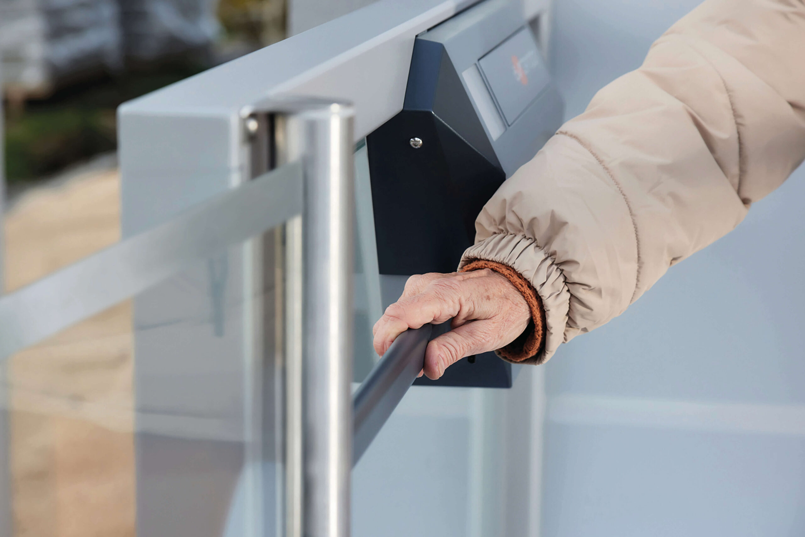 Person holding onto rails on a platform lift