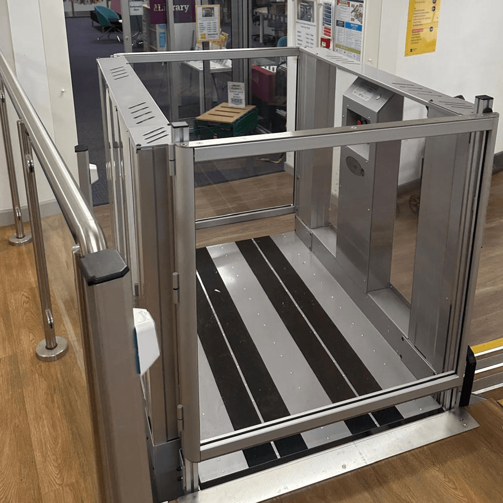 Step Lift in its raised position showing the anti-slip platform floor and clear side panels.