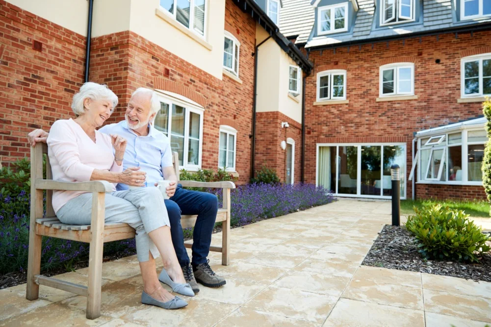 Elderly man and woman sat down in retirement home